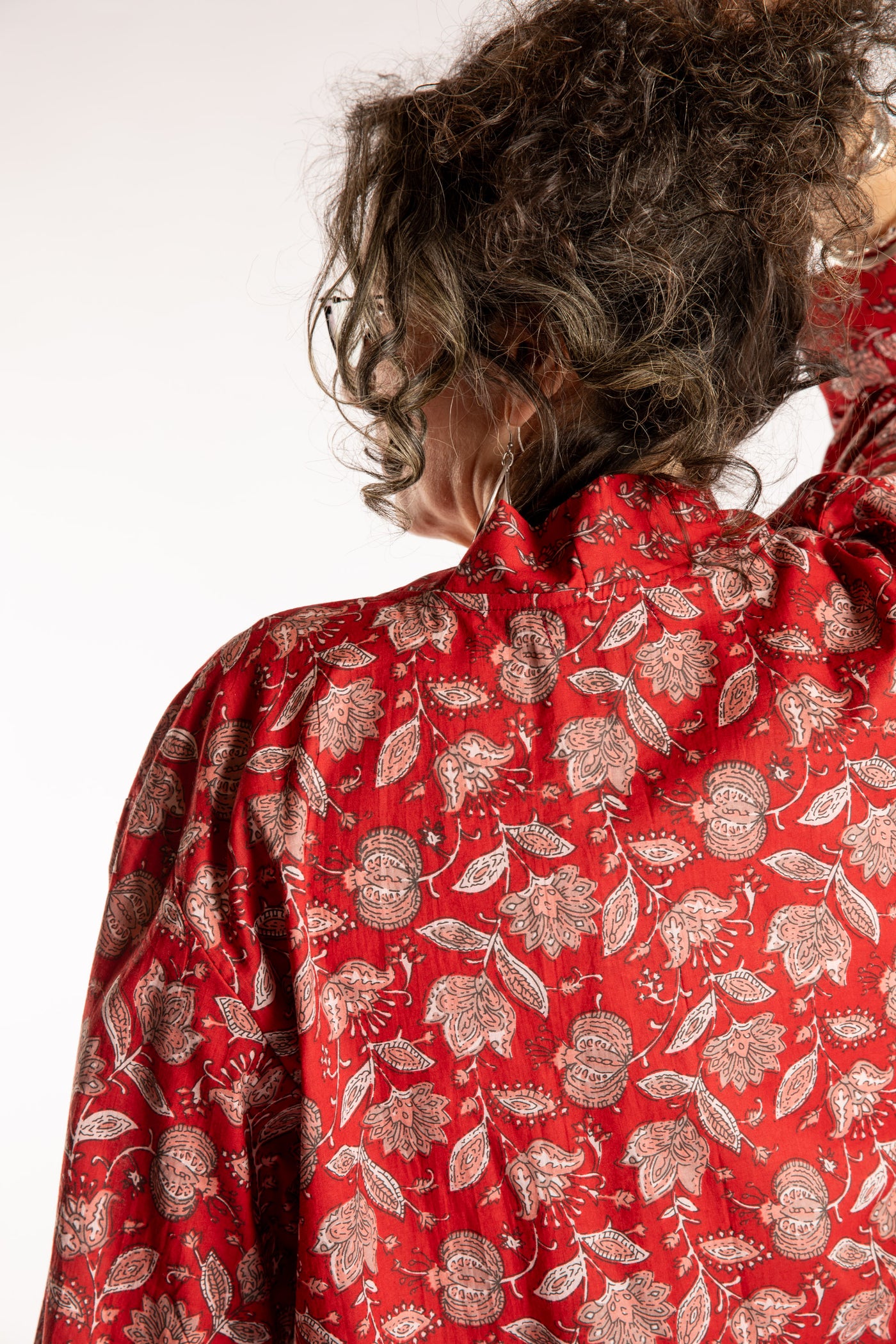 Susan is wearing the one size Kiraana cardigan in Red