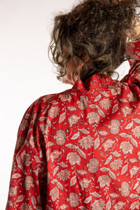 Susan is wearing the one size Kiraana cardigan in Red