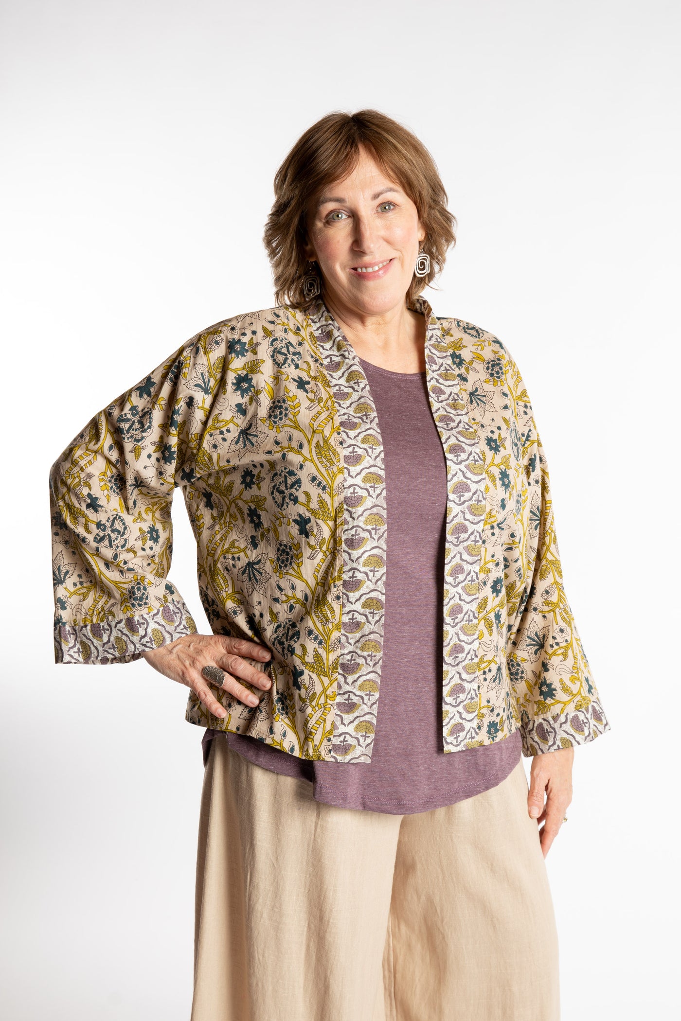Betty is wearing the one size Kiraana cardigan in Tan