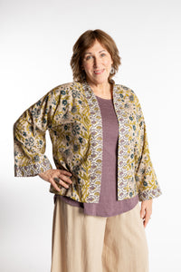 Betty is wearing the one size Kiraana cardigan in Tan