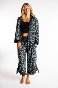 Sophie is wearing the Kiraana Tonal Crop Pants in Black S/M