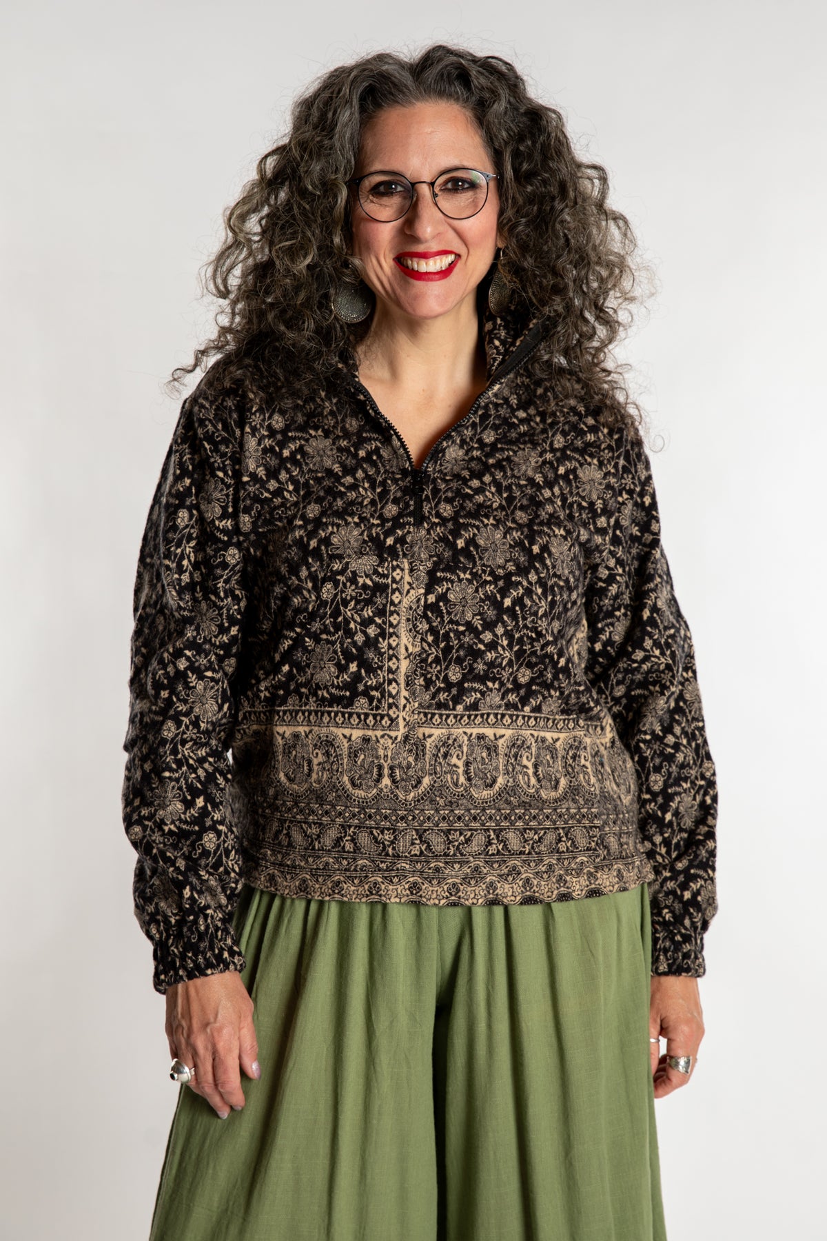 Susan is wearing the M/L Kiran Soft Brushed Quarter Zip Pullover in Black