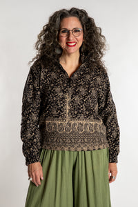 Susan is wearing the M/L Kiran Soft Brushed Quarter Zip Pullover in Black