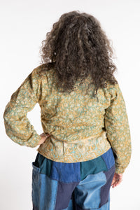 Susan is wearing the M/L Kiran Soft Brushed Quarter Zip Pullover in Green