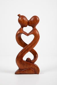 Kissing carved wooden sculpture in infinity