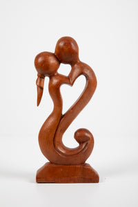 Kissing carved wooden sculpture in love