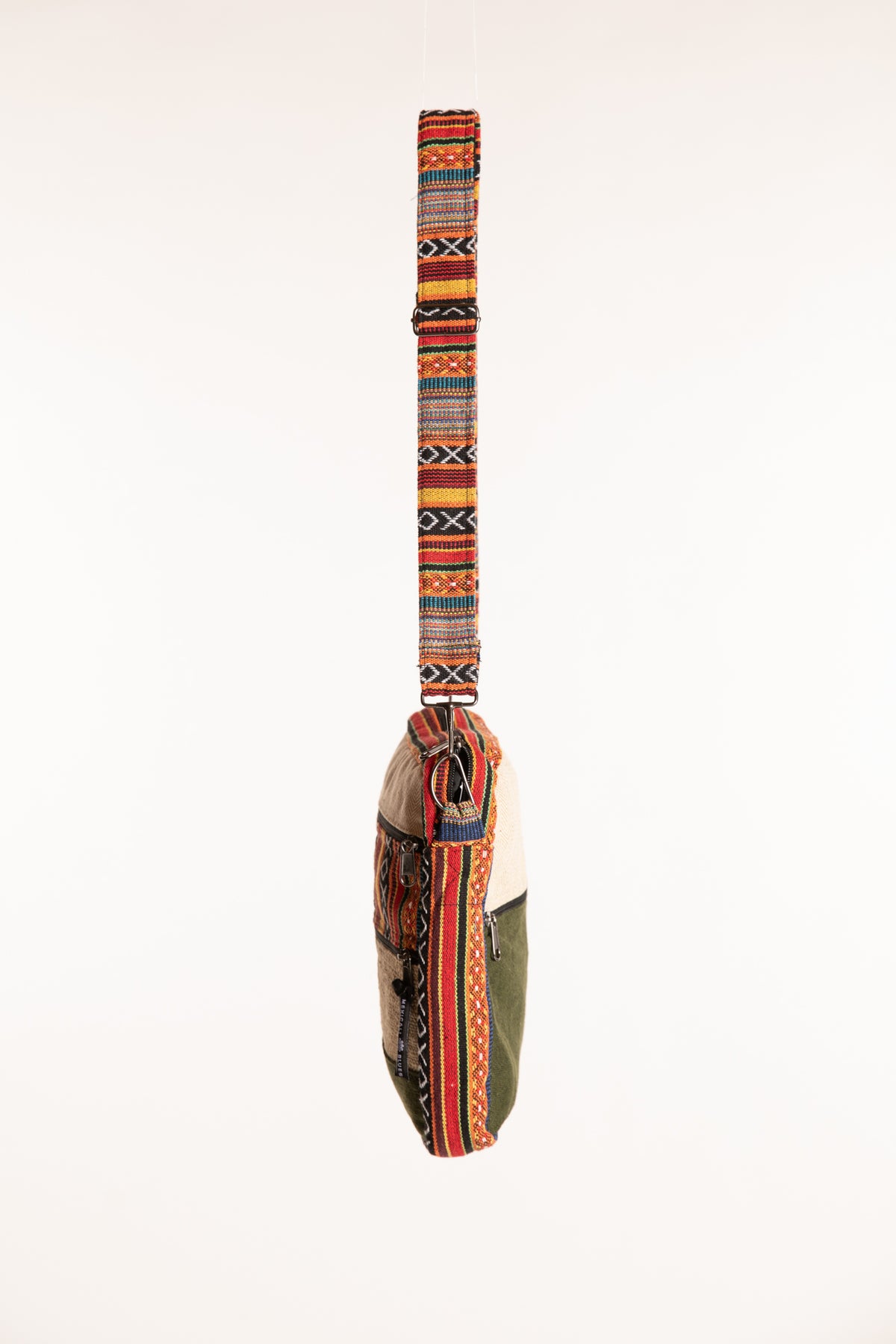 Side profile of slim hemp patchwork crossbody bag with adjustable shoulder strap