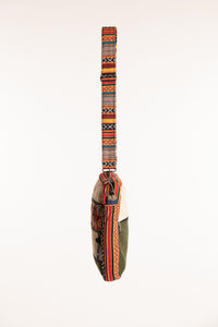 Side profile of slim hemp patchwork crossbody bag with adjustable shoulder strap