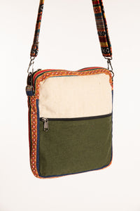 Close view of colorful striped patchwork detailing and zipper pockets on Koshi hemp bag