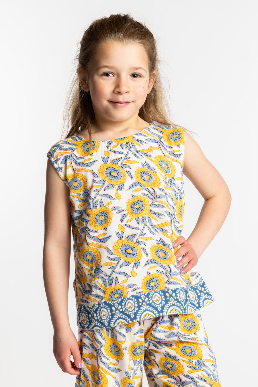 Louisa age 7 wearing size Small Sahana Contrast Hem Kids Top in sunflower print