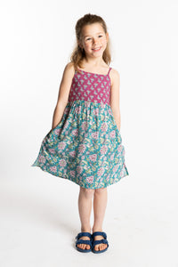Louisa is wearing the size M Aqua floral kids dress with smocked back
