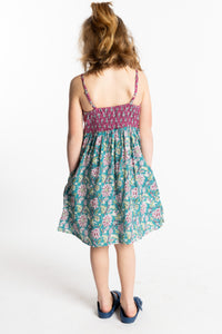 Louisa is wearing the size M Aqua floral kids dress with smocked back
