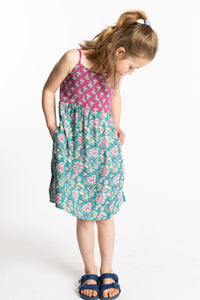 Louisa is wearing the size M Aqua floral kids dress with smocked back
