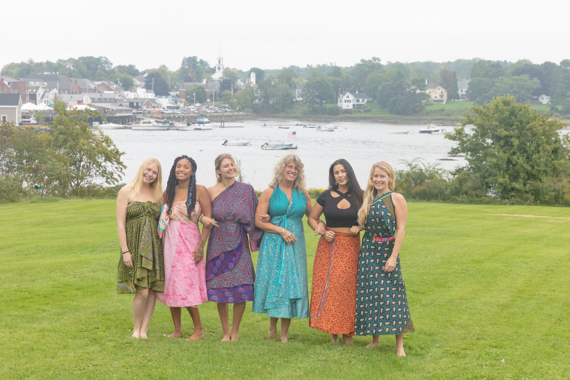 6 beautiful women by the water wearing colorful recycled silk sari magic skirts all tied in different ways