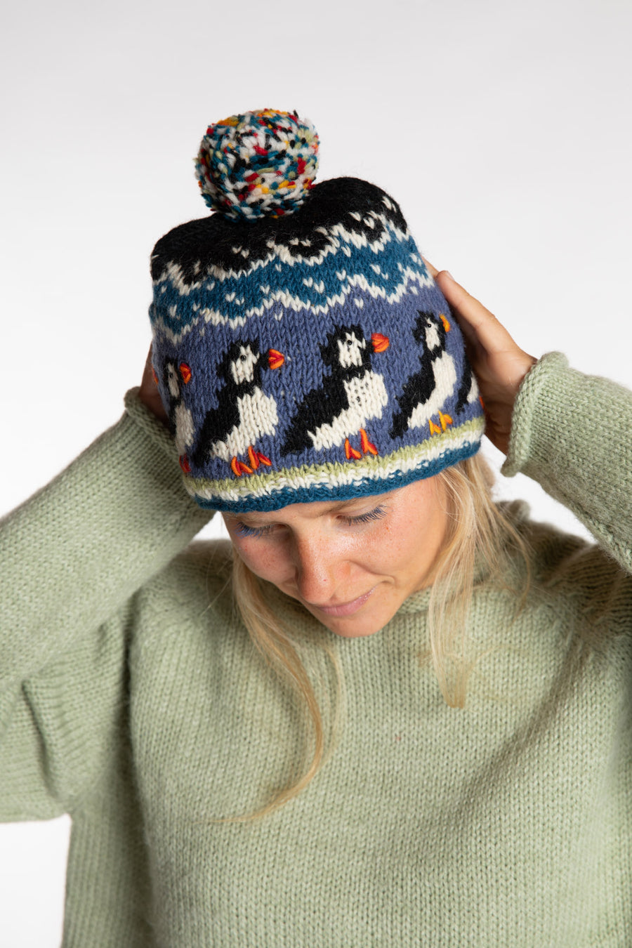 Sophie is wearing the Maine Puffin Hat in Blue