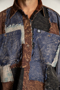 Topher is wearing the One Size Makalu Patchwork Overshirt in North Sea