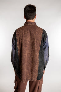Topher is wearing the One Size Makalu Patchwork Overshirt in North Sea