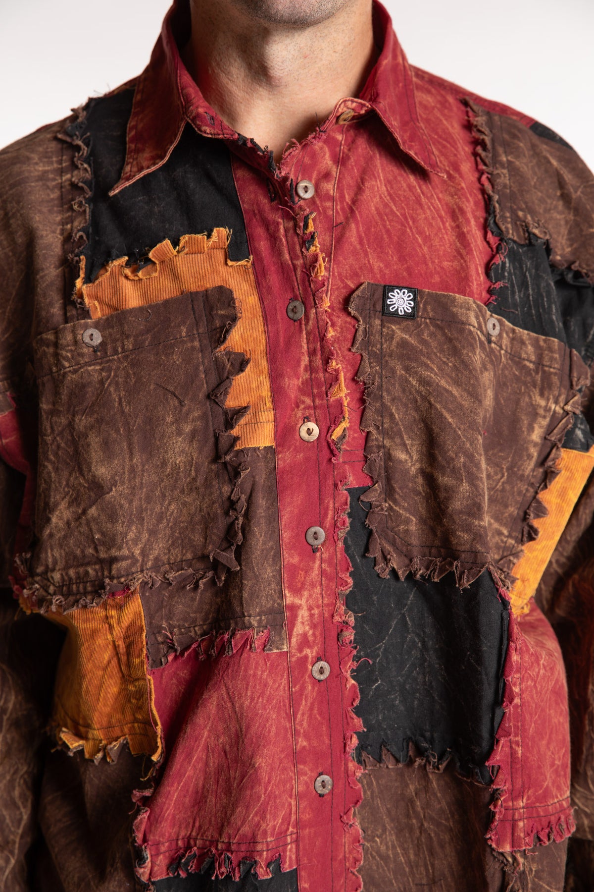Topher is wearing the One Size Makalu Patchwork Overshirt in Spice Harvest