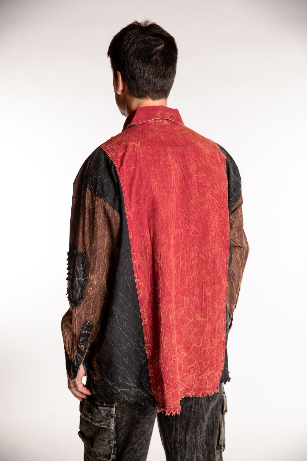 Topher is wearing the One Size Makalu Patchwork Overshirt in Spice Harvest