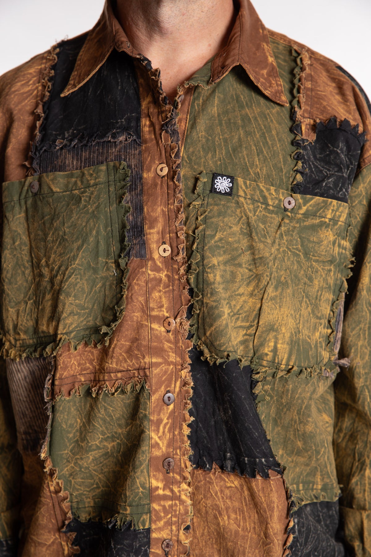 Topher is wearing the One Size Makalu Patchwork Overshirt in Timberline