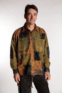 Topher is wearing the One Size Makalu Patchwork Overshirt in Timberline