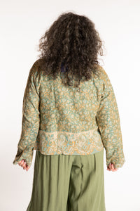 Susan is wearing the M/L Malini Soft Brushed Cardigan in Green