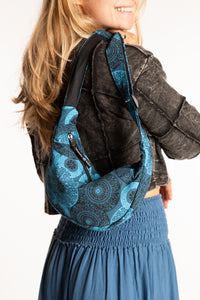 Sophie wearing blue mandala crescent crossbody bag