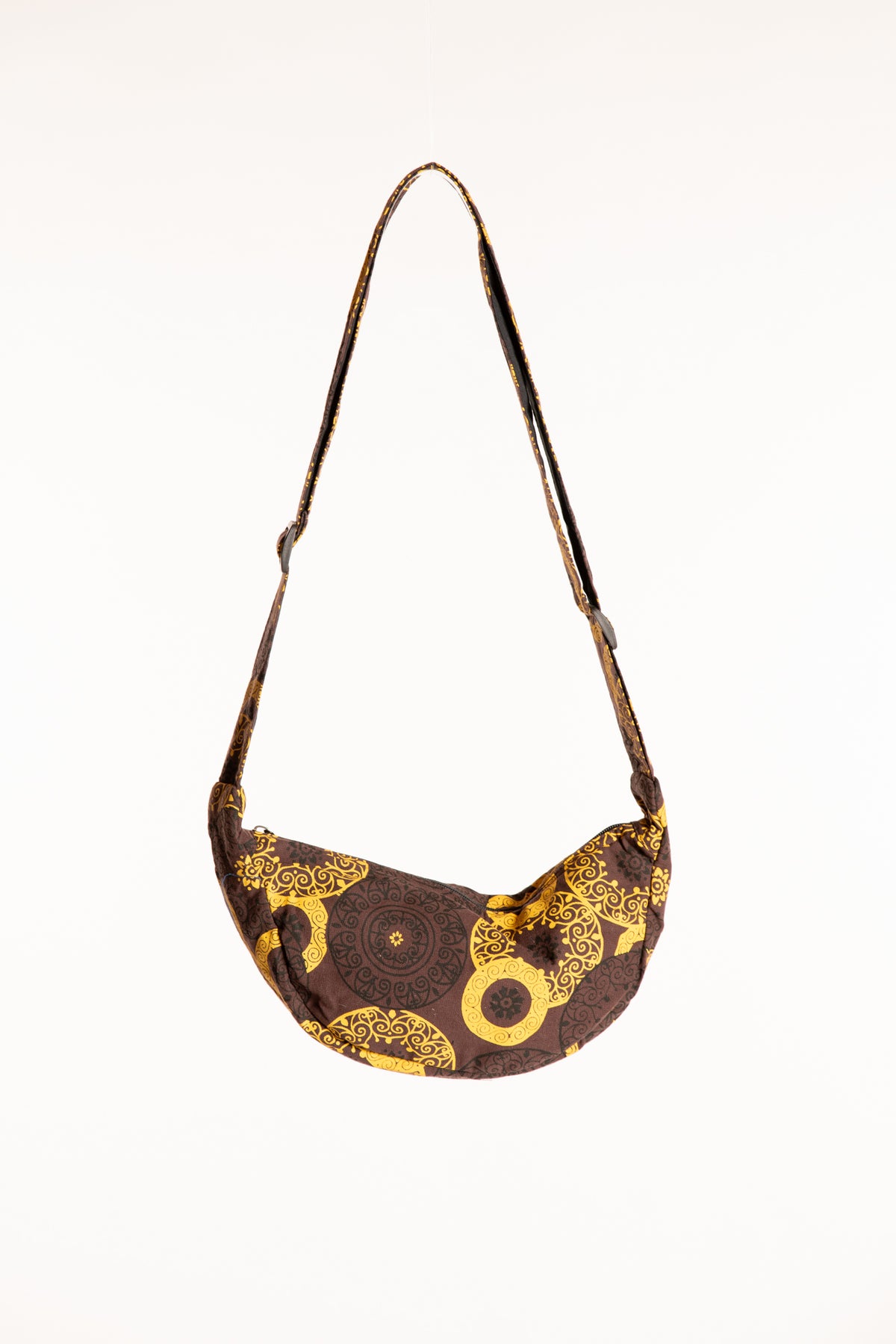 Brown and yellow cotton crescent crossbody bag with mandala inspired circular designs