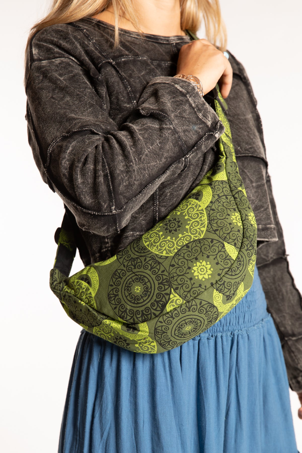 Sophie wearing a green mandala crescent crossbody bag