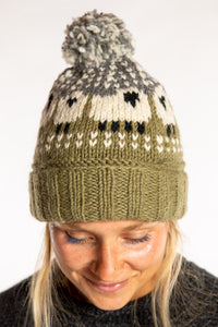 Sophie is wearing the Meadow Sheep Patterned Wool Pom Beanie in Fern