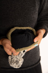 Sophie is wearing the Meadow Sheep Patterned Wool Pom Beanie in Fern