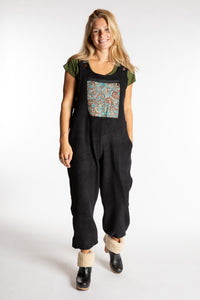 Sophie is wearing the S/M Mexicali Fleece Overalls in Black