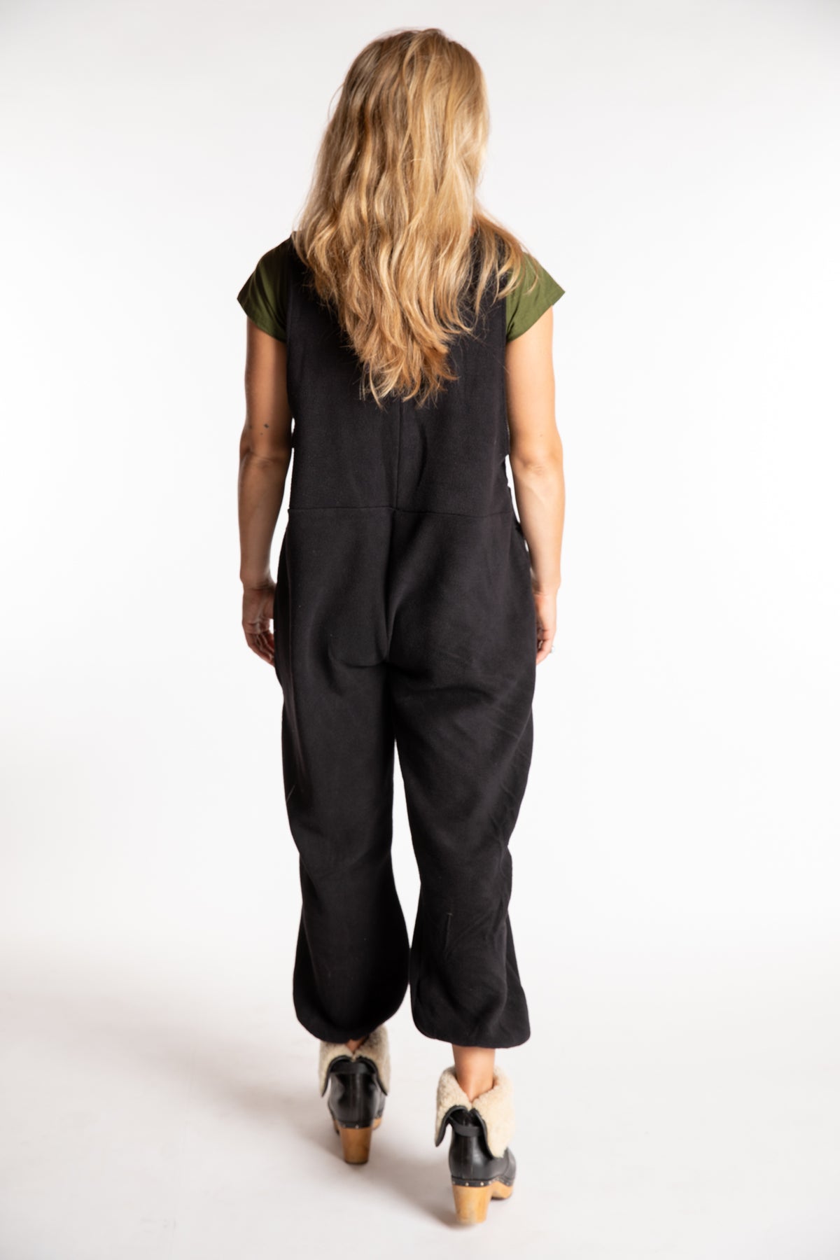 Sophie is wearing the S/M Mexicali Fleece Overalls in Black