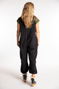 Sophie is wearing the S/M Mexicali Fleece Overalls in Black