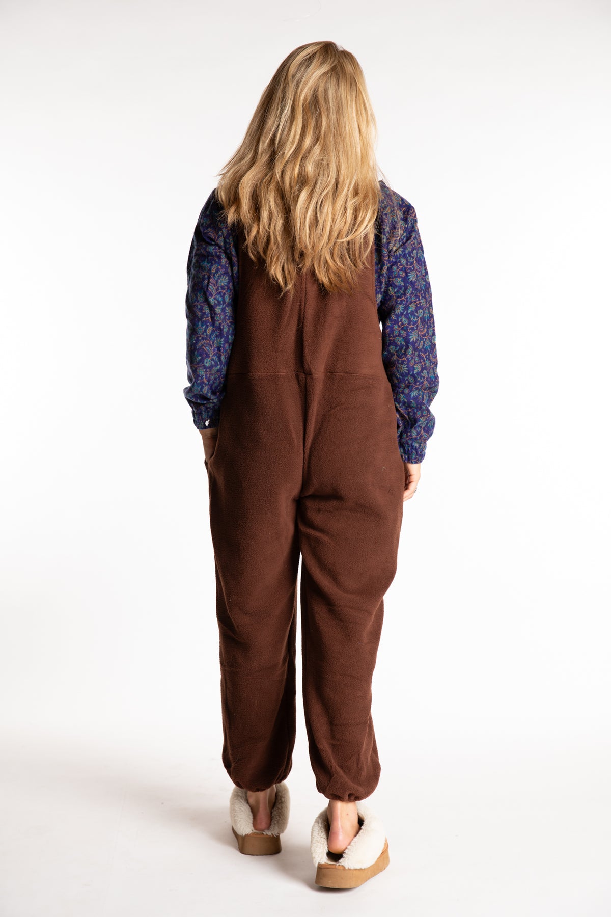 Sophie is wearing the S/M Mexicali Fleece Overalls in Brown