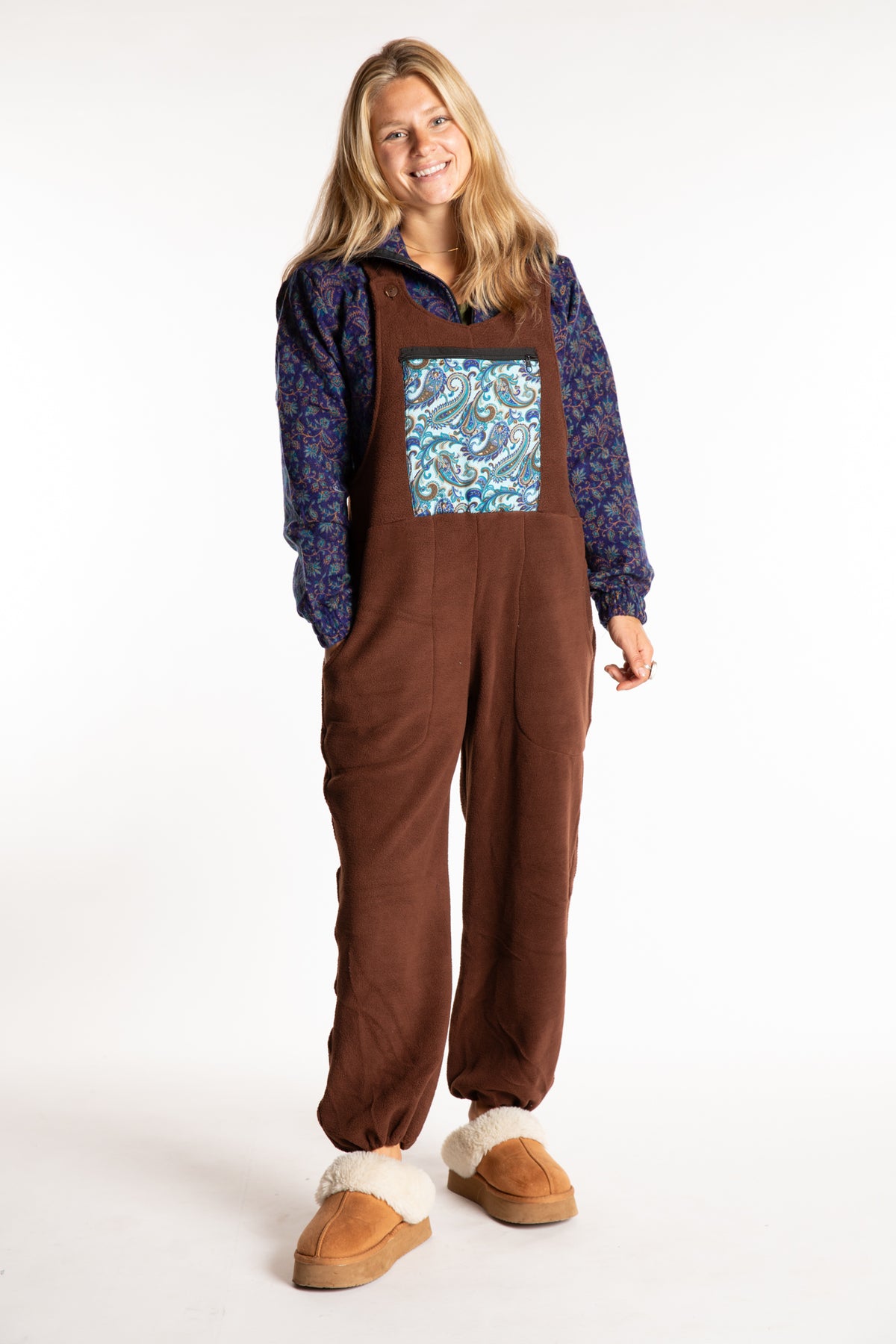 Sophie is wearing the S/M Mexicali Fleece Overalls in Brown