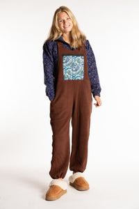Sophie is wearing the S/M Mexicali Fleece Overalls in Brown
