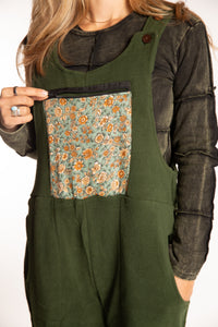 Sophie is wearing the S/M Mexicali Fleece Overalls in Green