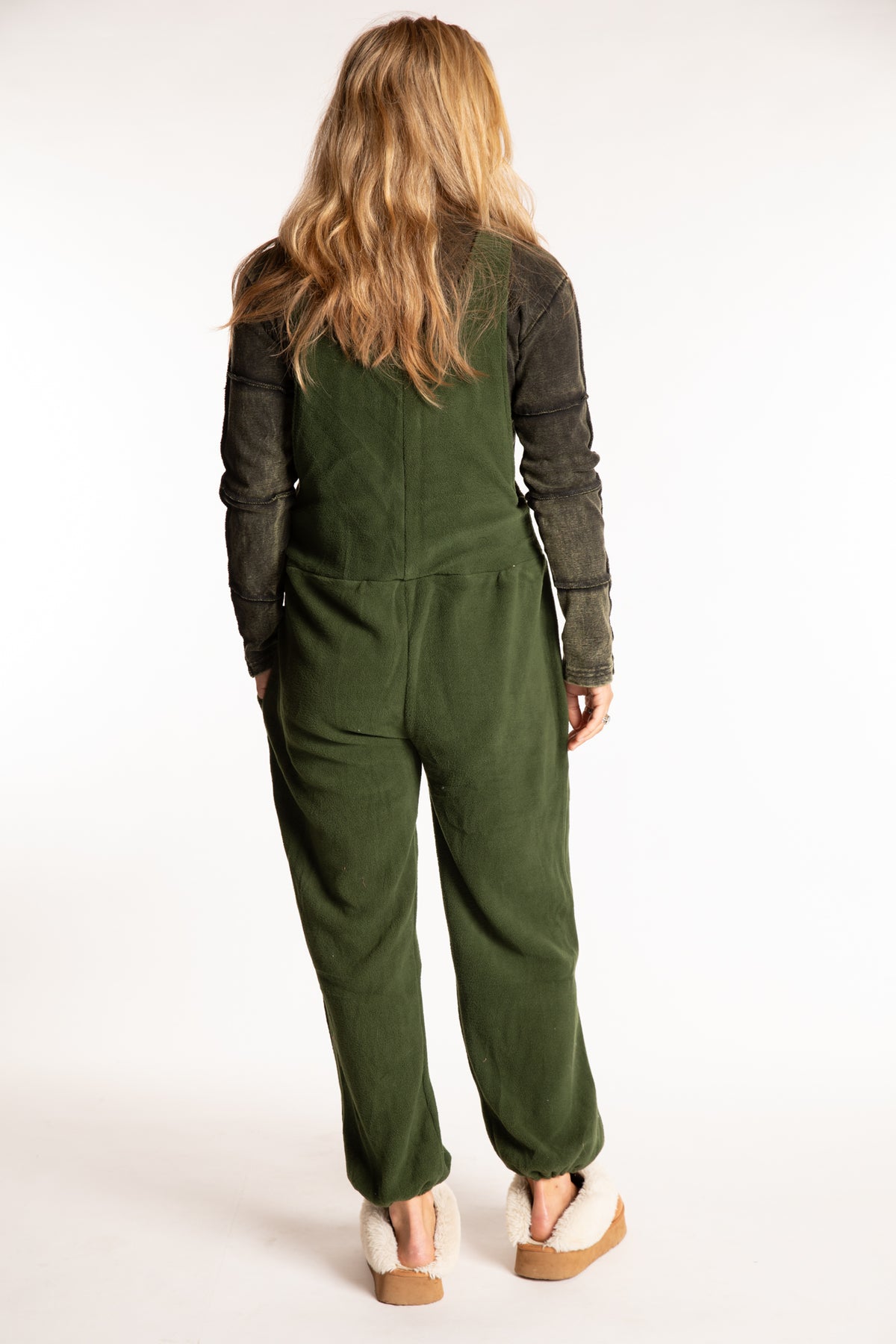 Sophie is wearing the S/M Mexicali Fleece Overalls in Green