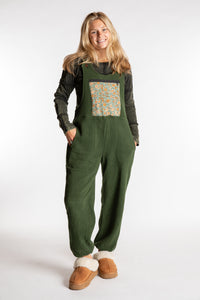Sophie is wearing the S/M Mexicali Fleece Overalls in Green