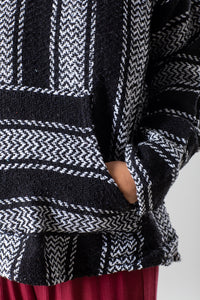 Sophie is wearing size M baja hoodie in black