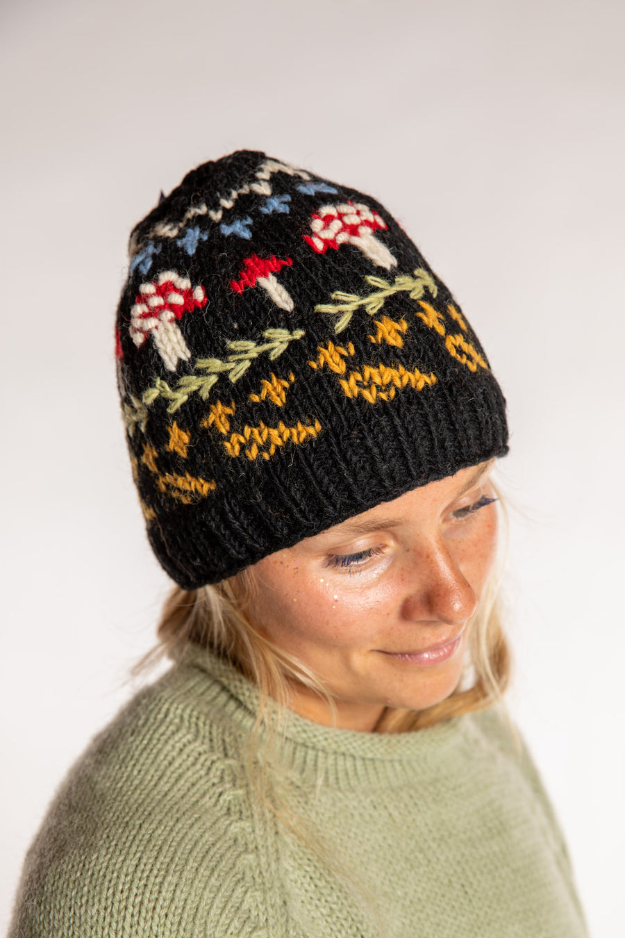 Sophie is wearing the Mushroom Meadow Wool Beanie in Black