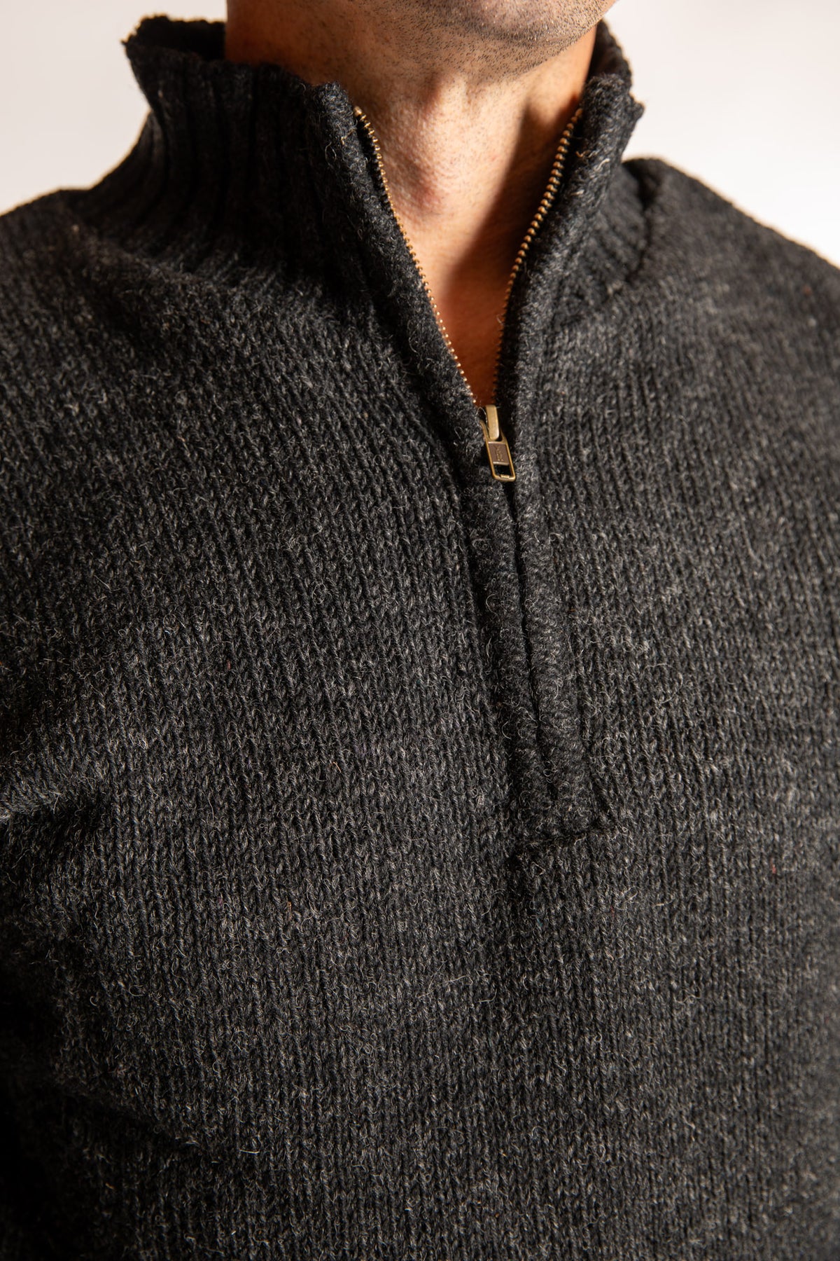 Topher is wearing the Large Nordic Quarter Zip Wool Sweater in Charcoal