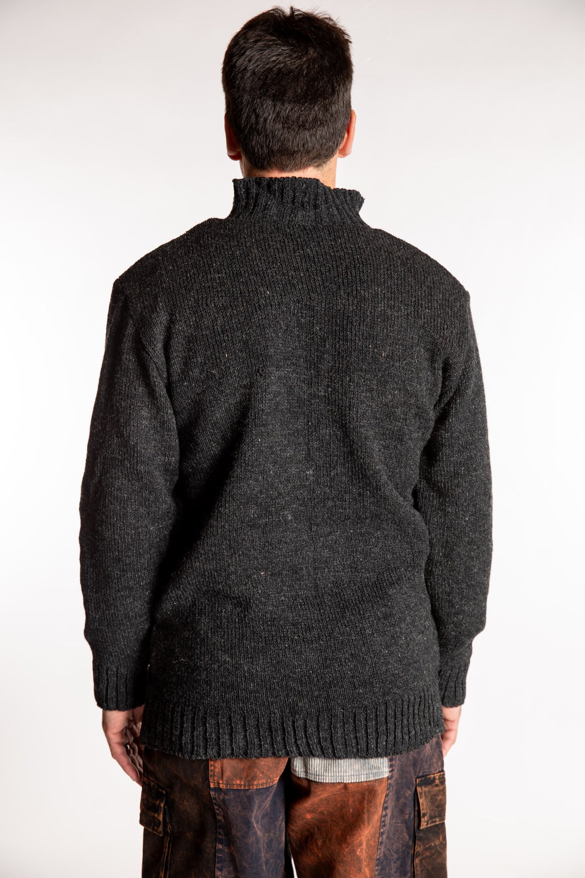 Topher is wearing the Large Nordic Quarter Zip Wool Sweater in Charcoal