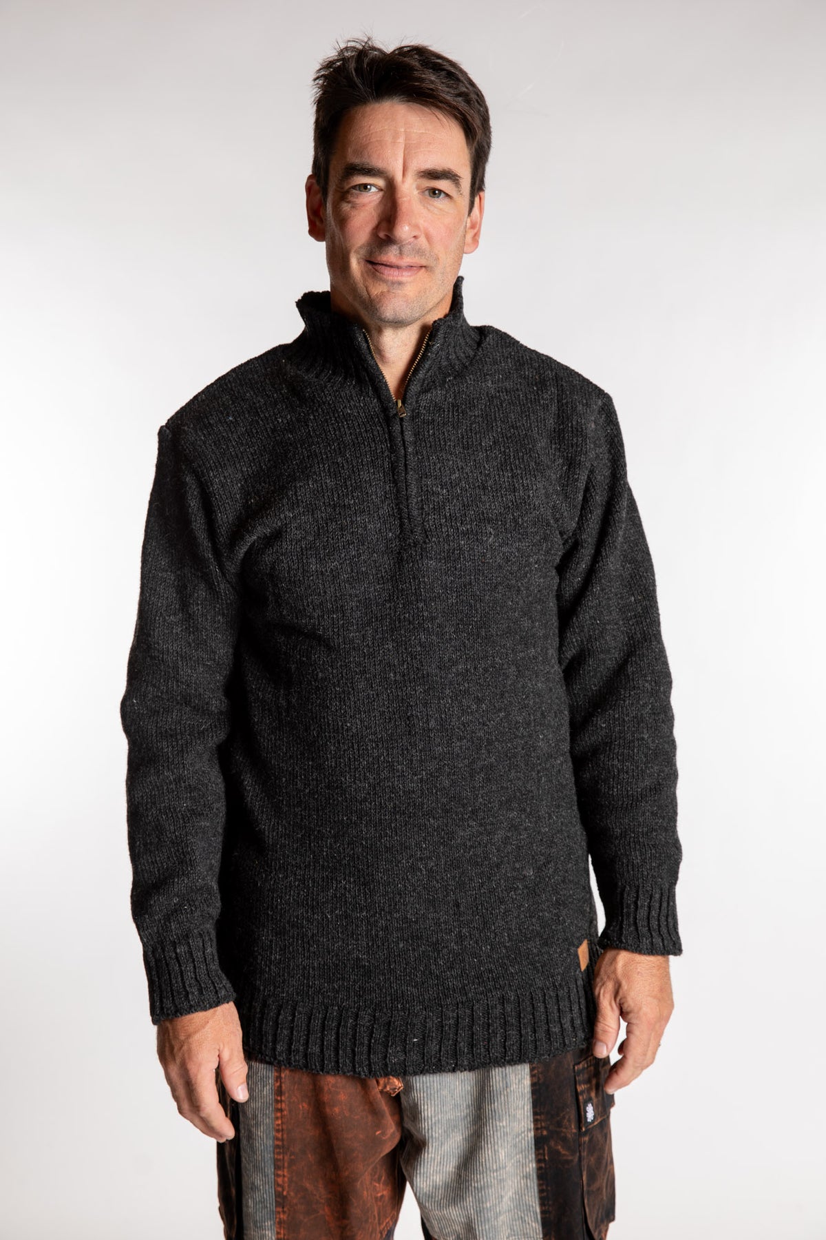 Topher is wearing the Large Nordic Quarter Zip Wool Sweater in Charcoal