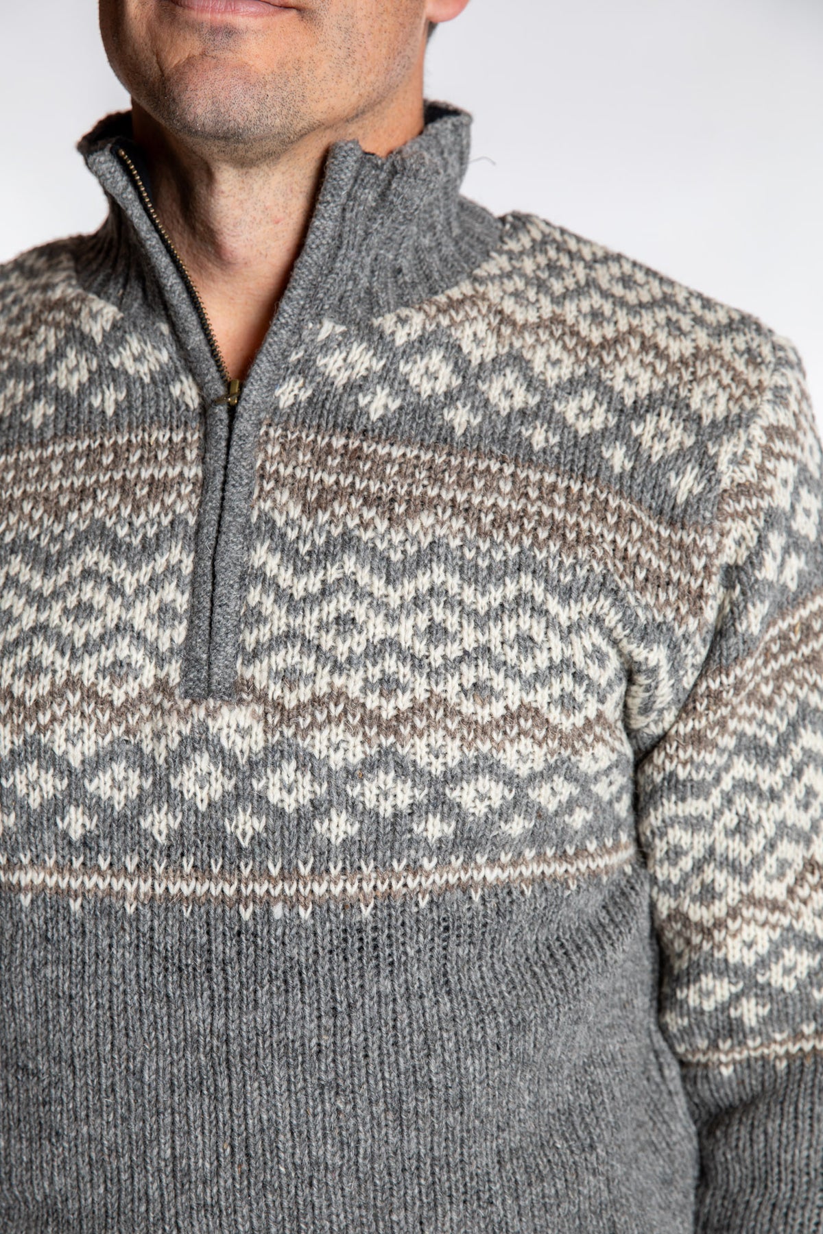 Topher is wearing the Large Nordic Quarter Zip Wool Sweater in Light Gray Pattern