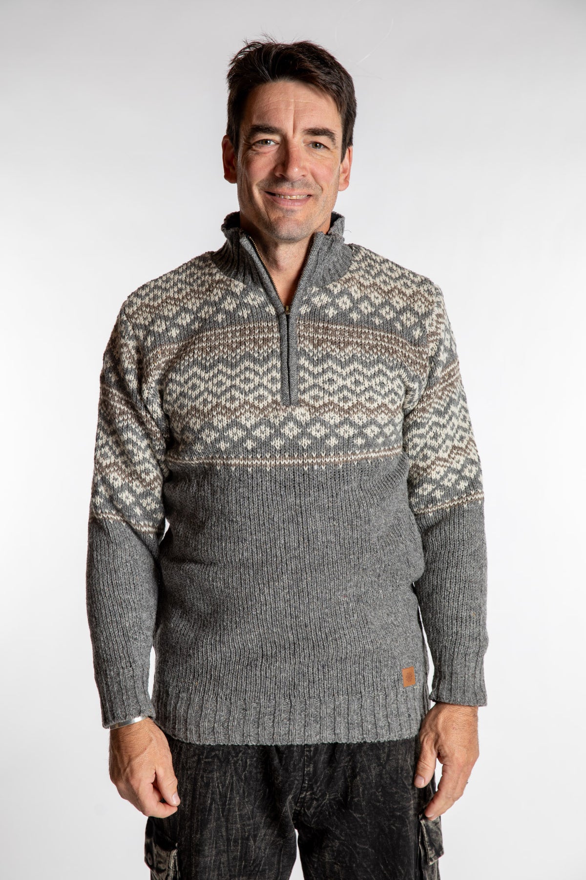Topher is wearing the Large Nordic Quarter Zip Wool Sweater in Light Gray Pattern