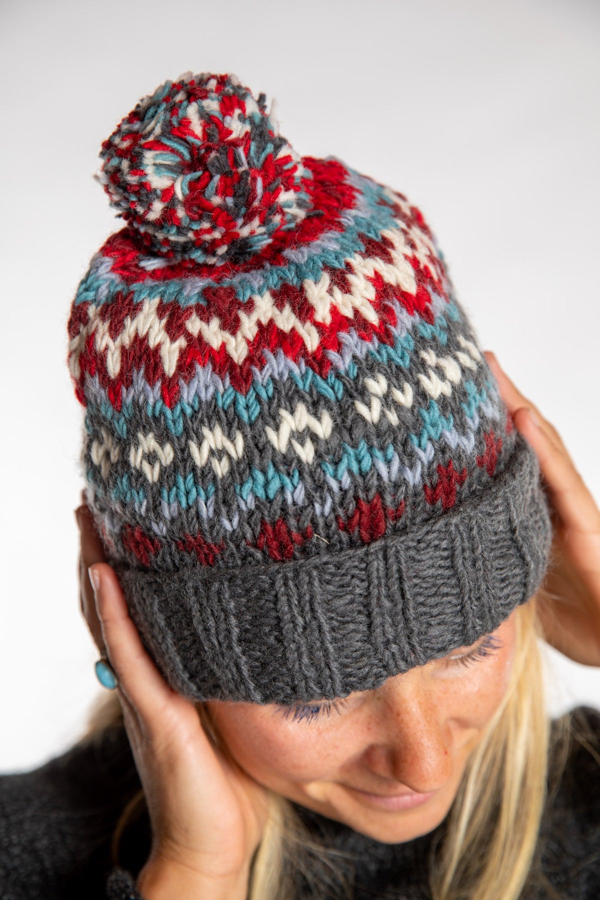 Sophie is wearing the North Country Patterned Wool Pom Bean in Red