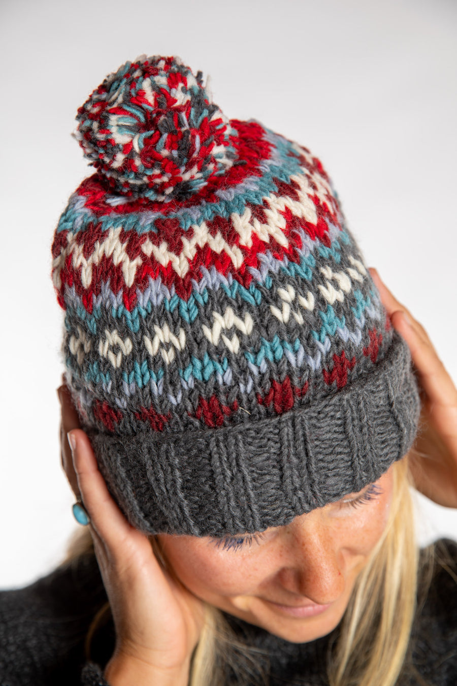 Sophie is wearing the North Country Patterned Wool Pom Bean in Red