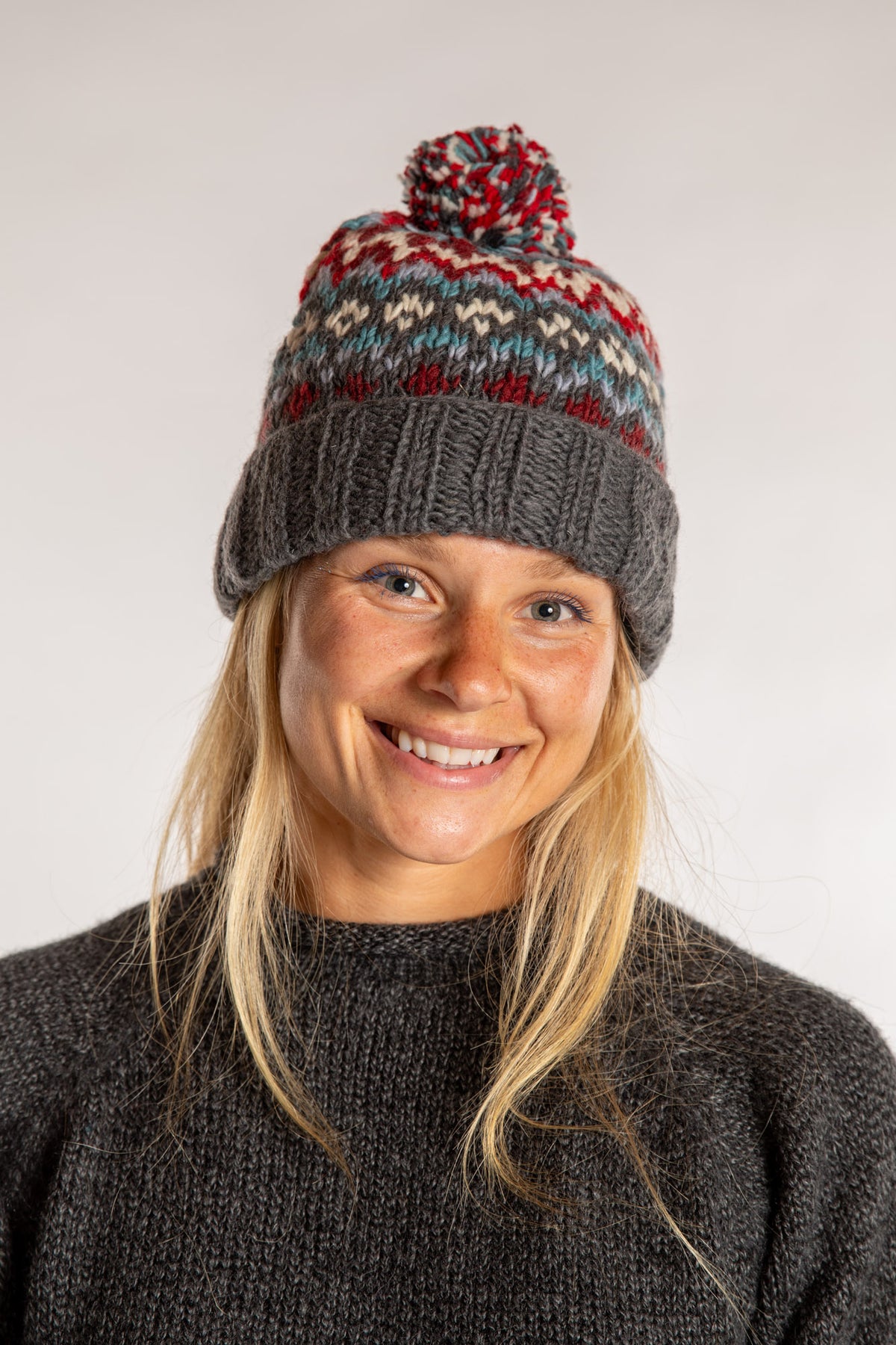 Sophie is wearing the North Country Patterned Wool Pom Bean in Red